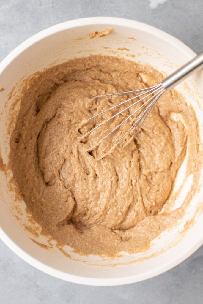 Healthy Blueberry Muffin Batter being whisked together in a white bowl