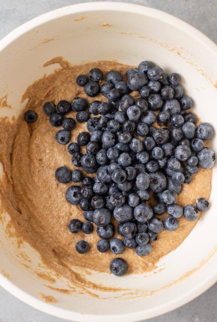 Blueberries being added to gluten free blueberry muffin batter