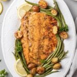 Lemon Salmon on a white plate with ingredients off to the side