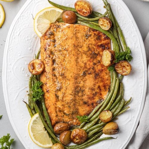 Lemon Salmon on a white plate with ingredients off to the side