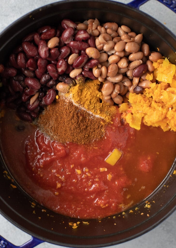 Vegetarian chili ingredients being added together to a pot