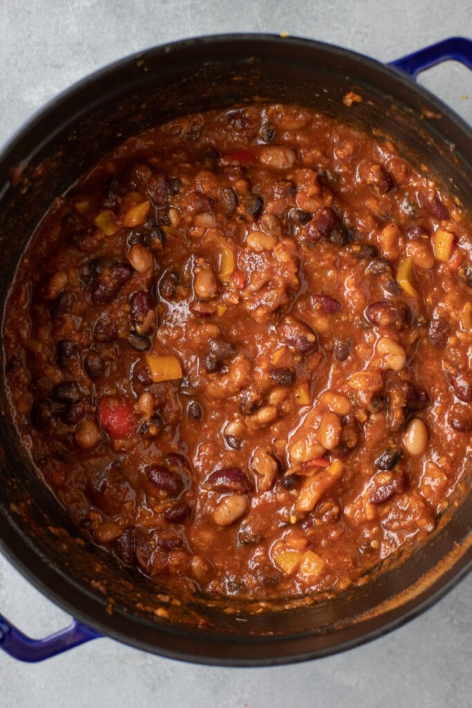 a close up of vegetarian chili in a blue dutch oven