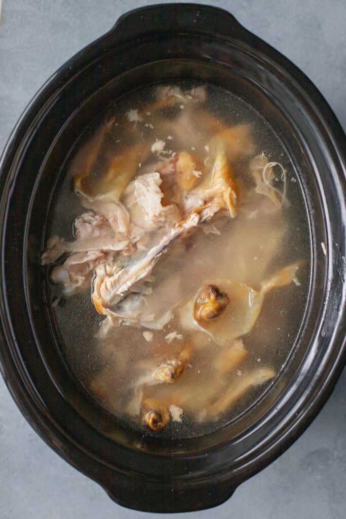 Chicken Bone broth in the crockpot before it has been cooked