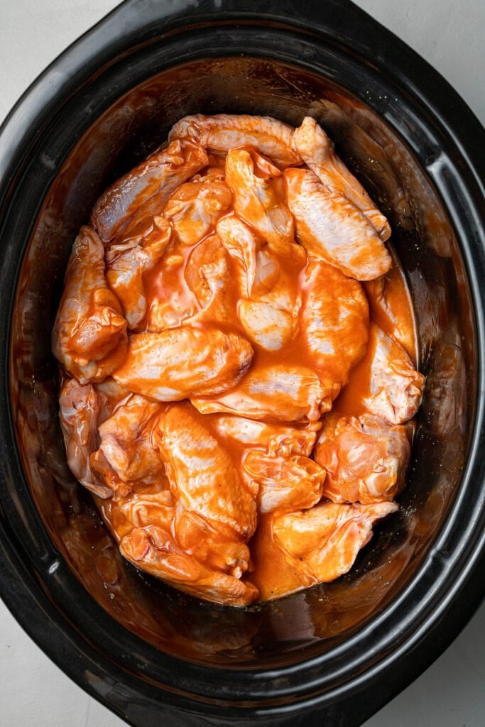 Chicken wings tossed in sauce in a crockpot