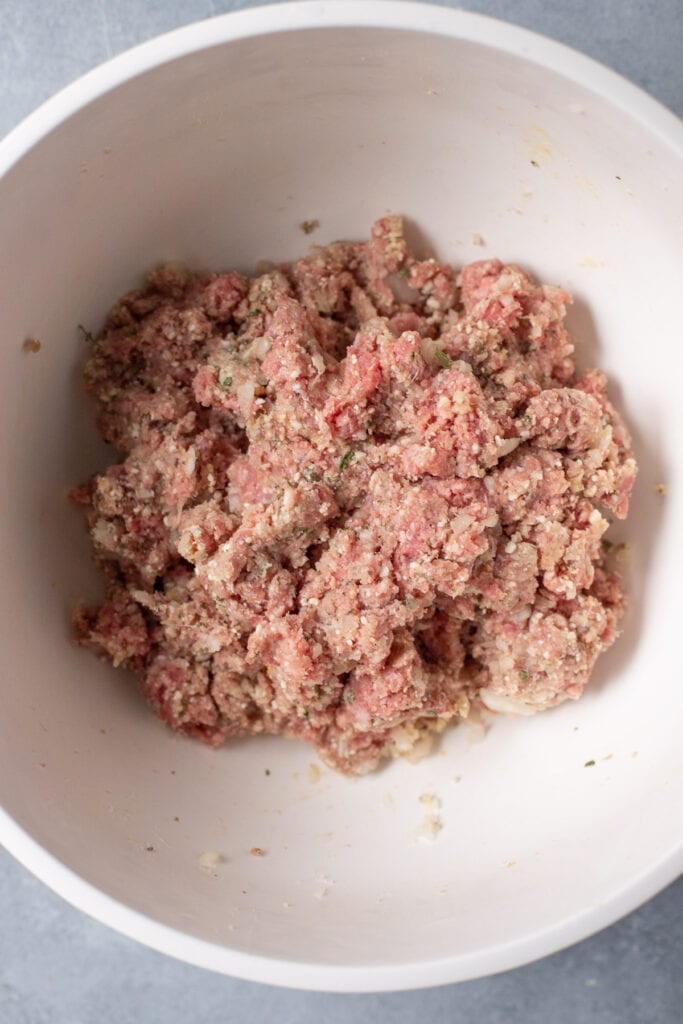 A bowl of raw homemade meatball bater before being rolled into balls