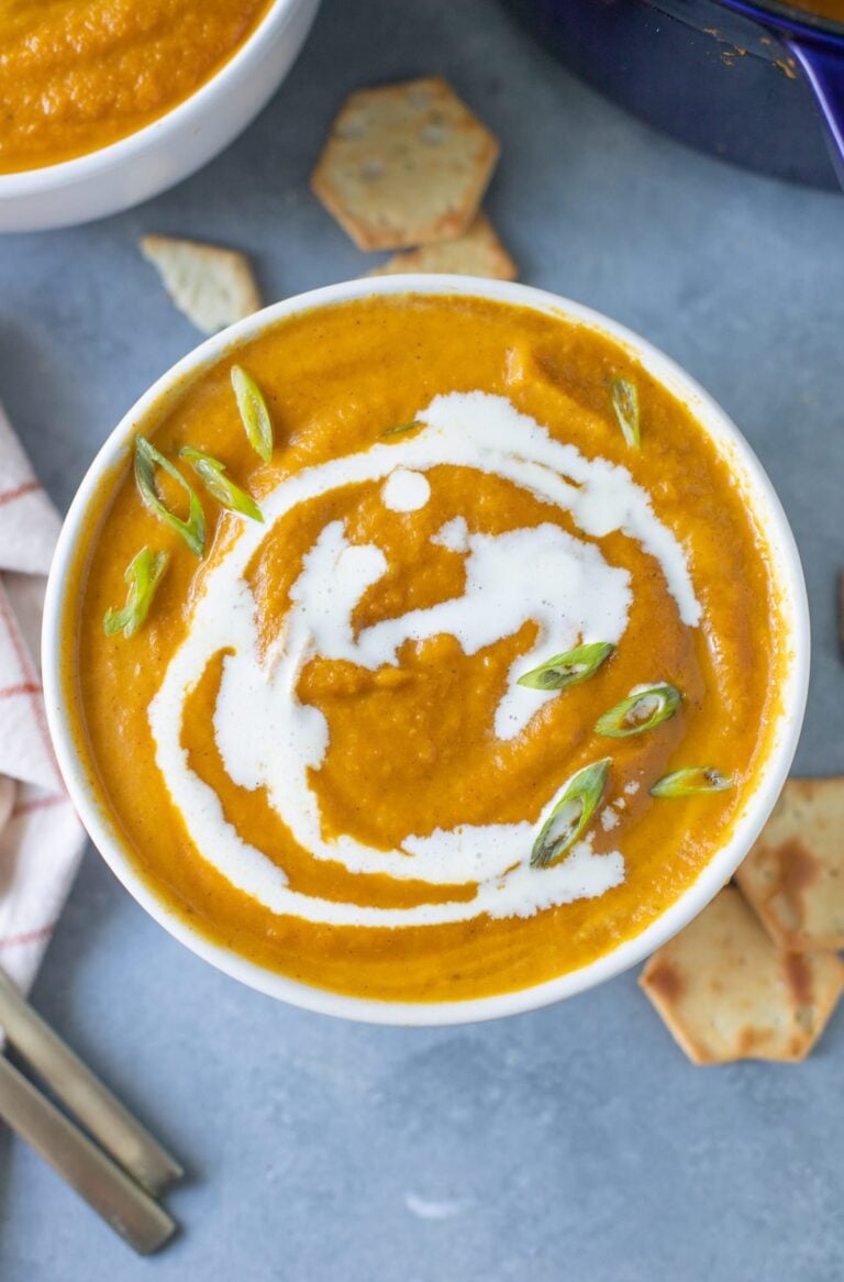 A bowl of Creamy Pumpkin Soup on a grey background