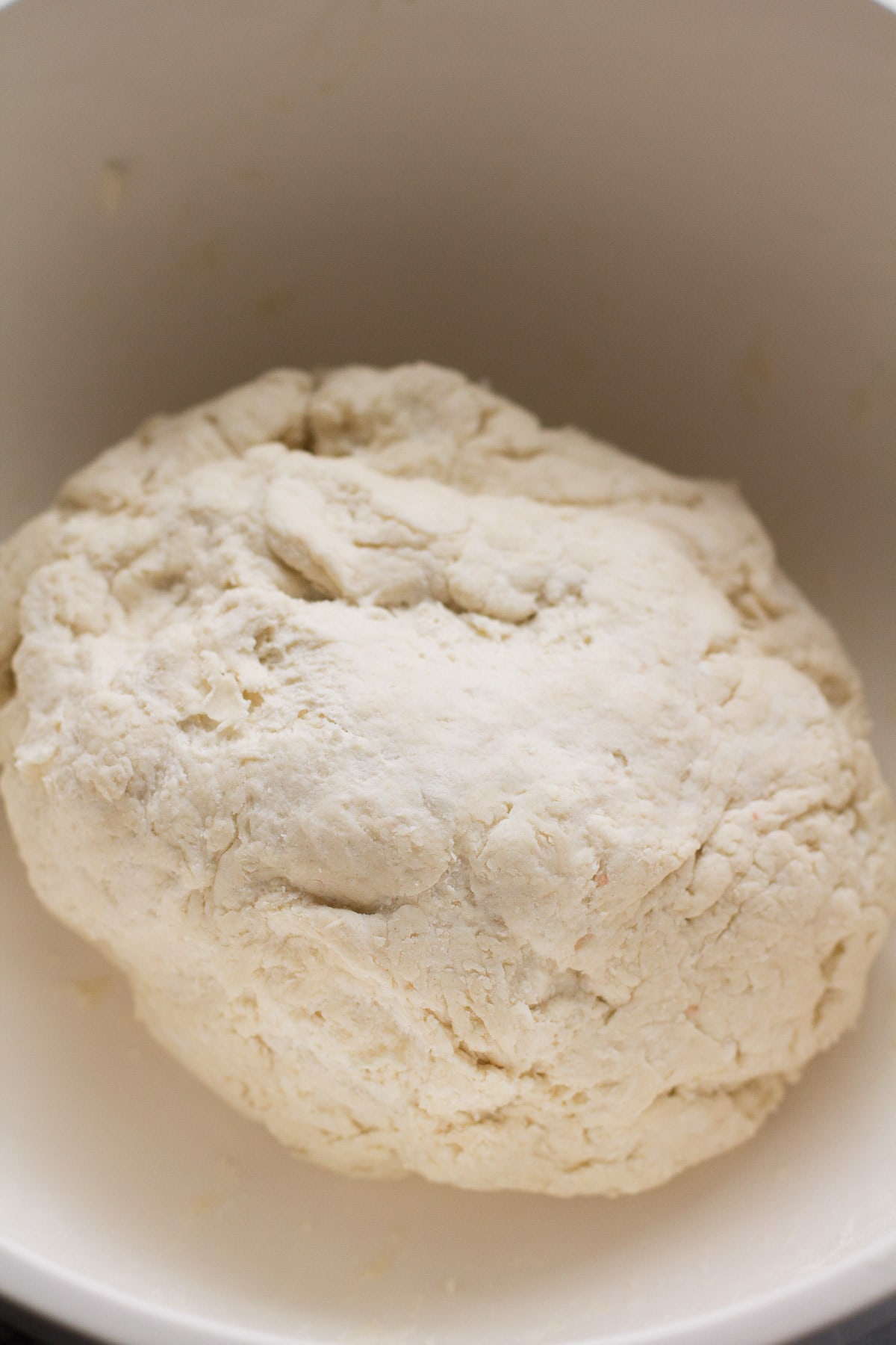 Large ball of dough in a bowl before being kneaded