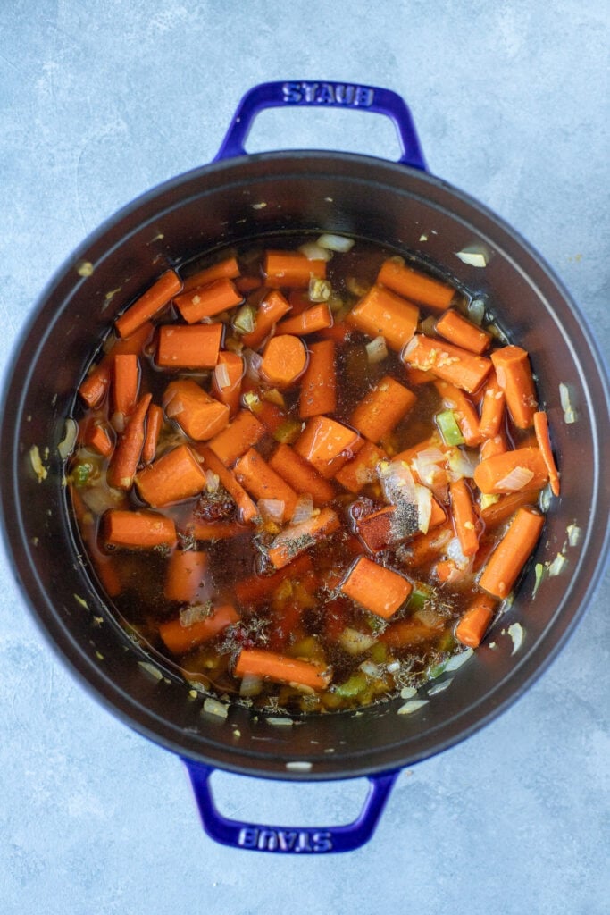 All ingredients for Carrot Ginger soup in a stock pot