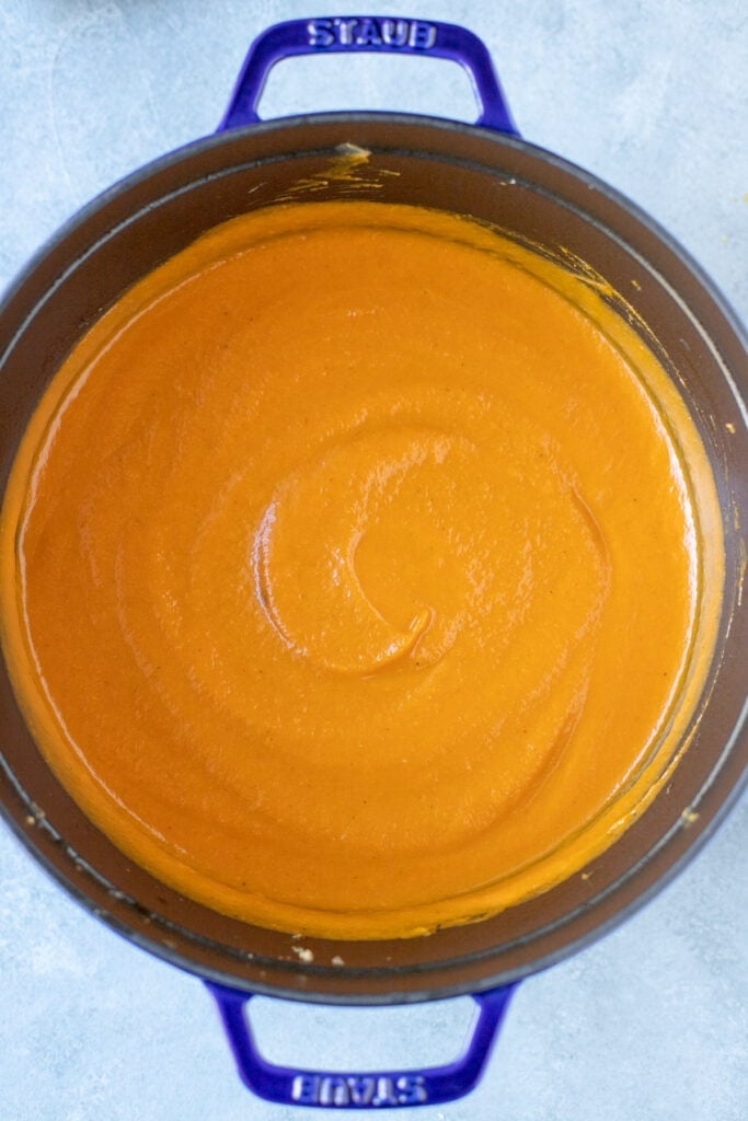 Carrot and ginger soup blended in a large pot