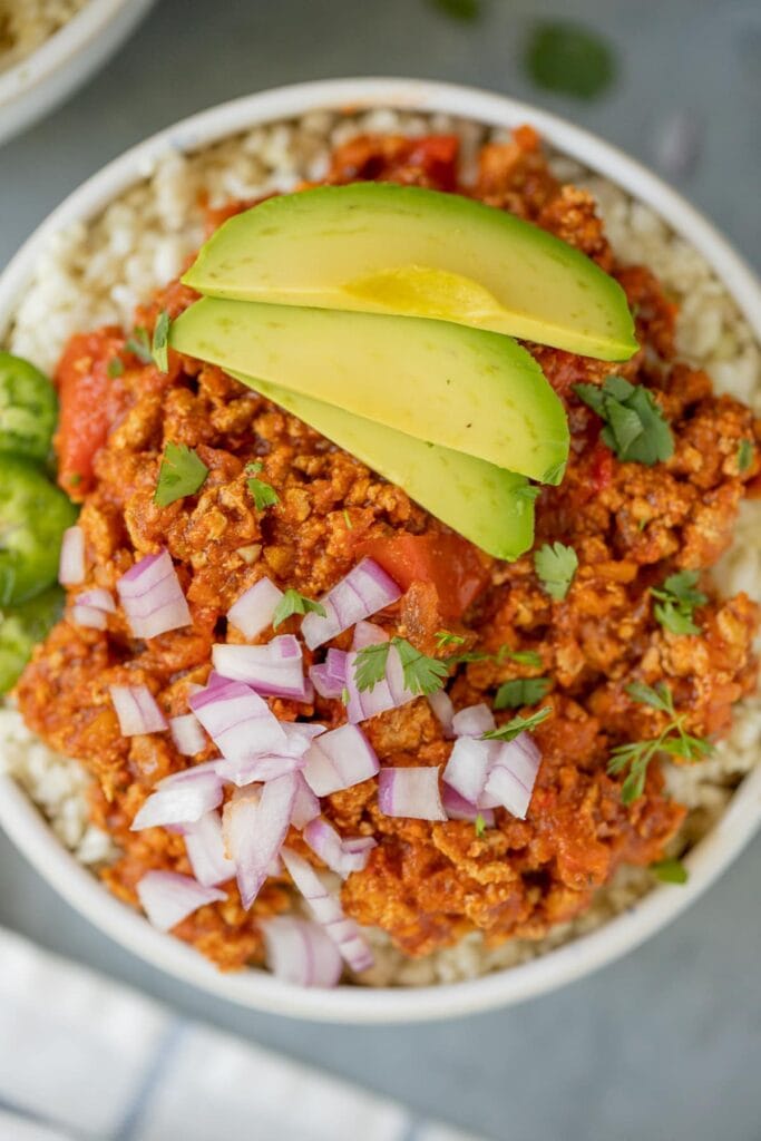 A close up of healthy turkey chili on a grey background - a whole30 crockpot recipe