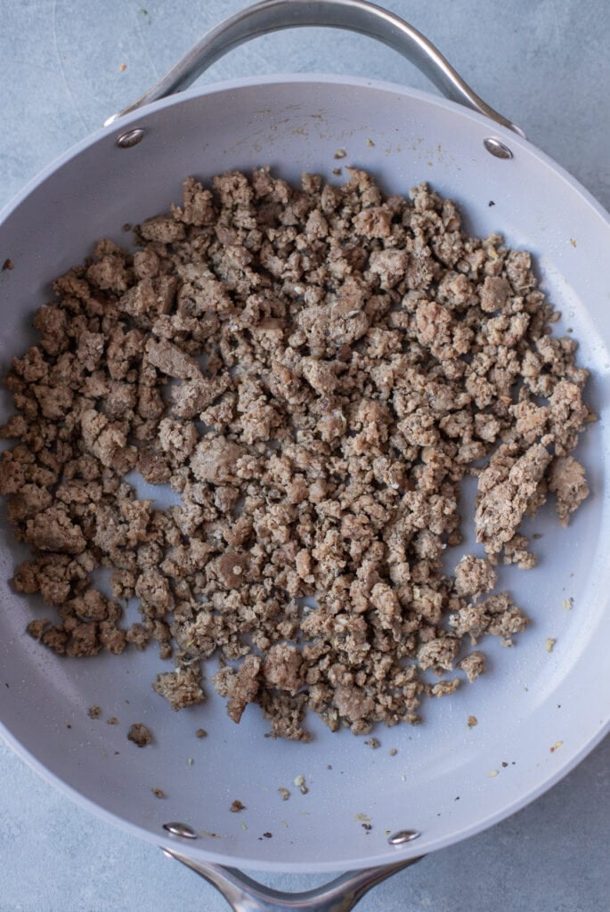 Browned ground turkey in a skillet, viewed from overhead.