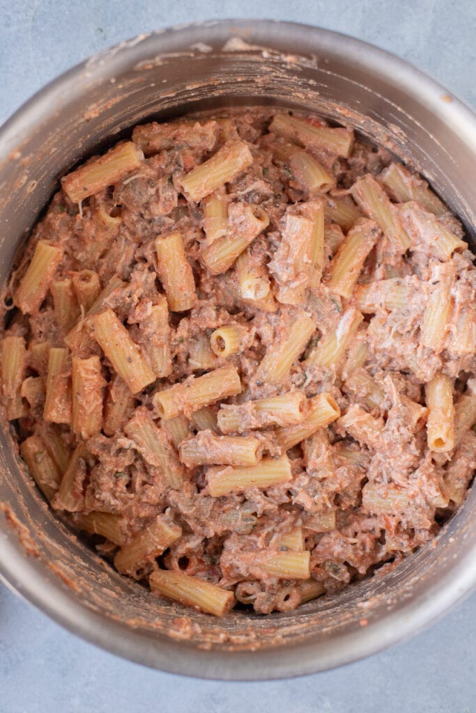 Ingredients for healthy baked ziti combined in a large pot, viewed from above.