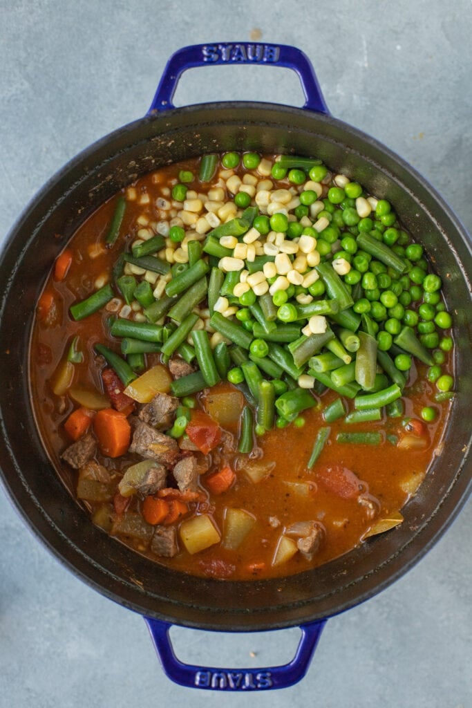 Beef and vegetable soup with frozen corn, frozen peas, frozen green beans add to the stock pot