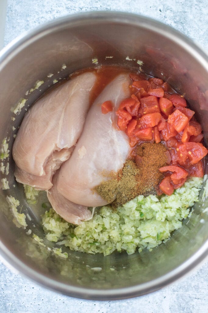 chicken, vegetables, broth, tomatoes and spices in the pot for chicken tortilla soup