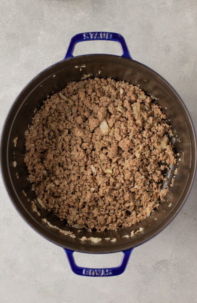 Browned ground beef, onion and garlic in a stock pot for stuffed pepper soup