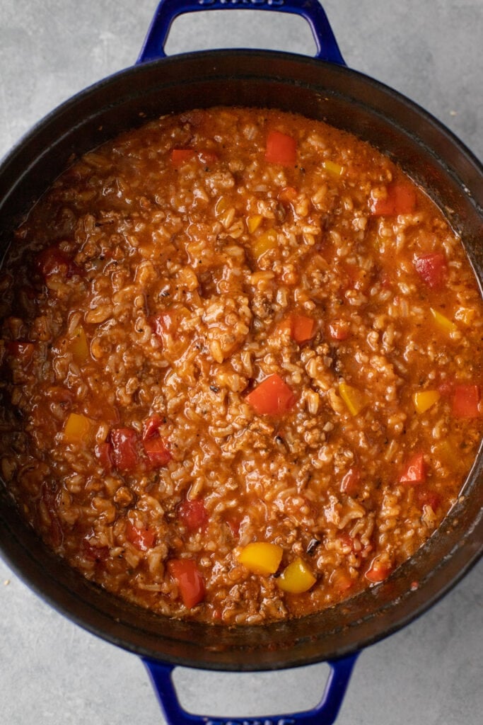 Stuffed bell pepper soup in a stock pot on a gray background