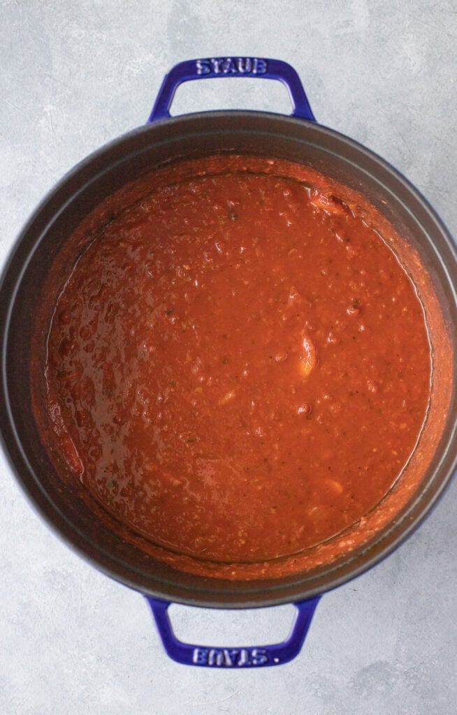 A stock pot of tomato basil soup (without milk) after cooking, but prior to blending