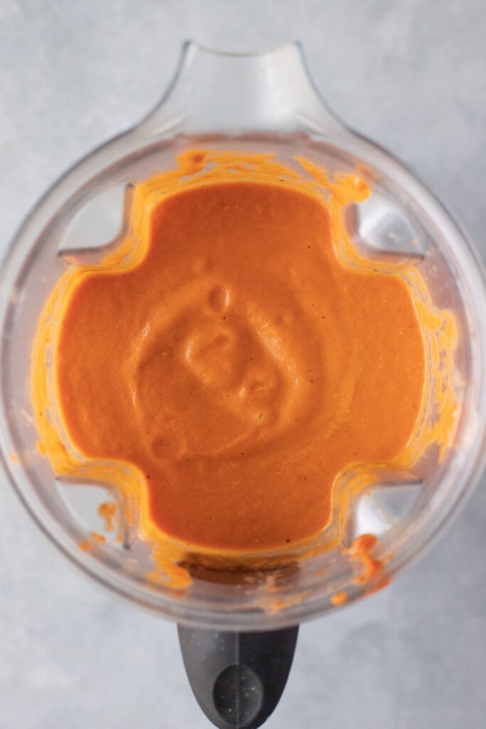 A blender of tomato basil soup after being blended
