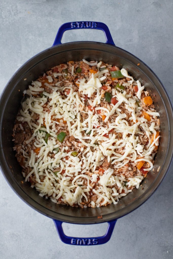 a dutch oven with ingredients for stuffed pepper casserole uncooked