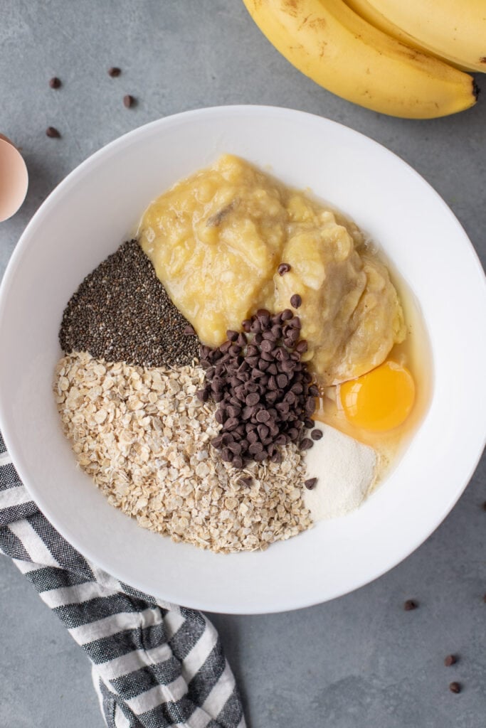 all ingredients for banana breakfast cookies in a white bowl unmixed