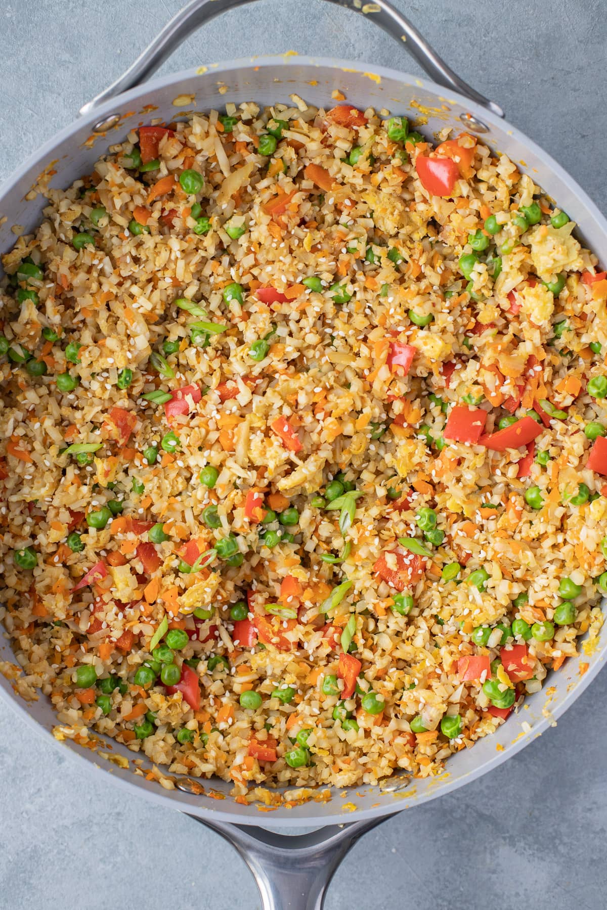 Fried Cauliflower rice in a pan on a grey background