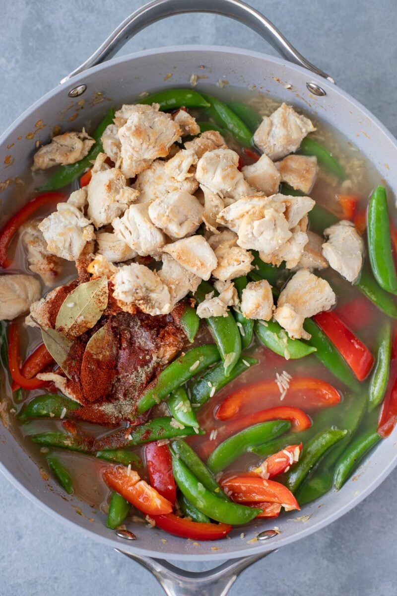 All ingredients for chicken paella in a pan uncooked
