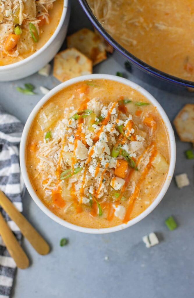Crockpot Buffalo Chicken Soup in a white bowl on a grey background