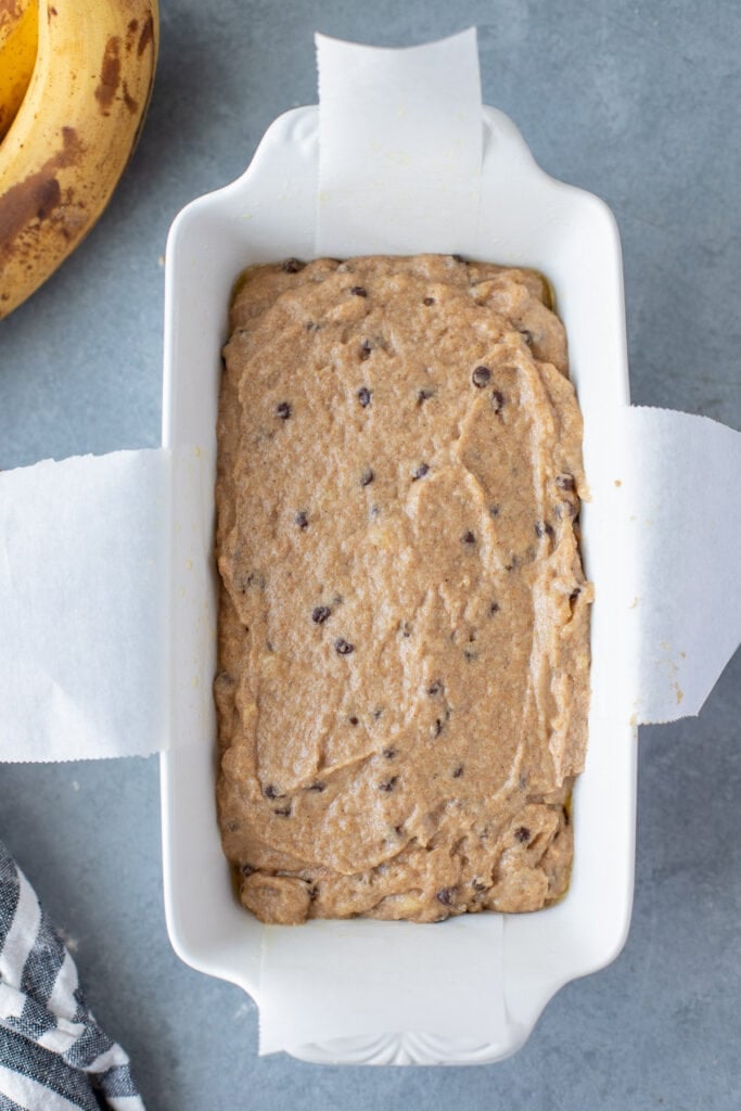 healthy banana bread mixture in a white loaf pan, uncooked