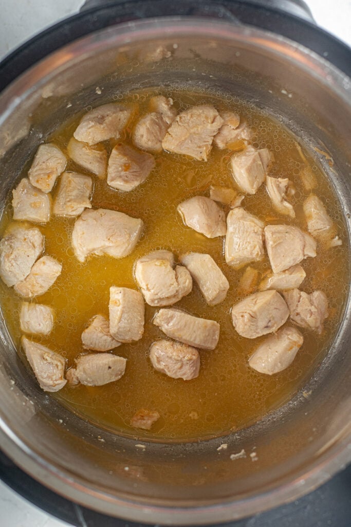 Orange chicken in the instant pot the sauce being added in