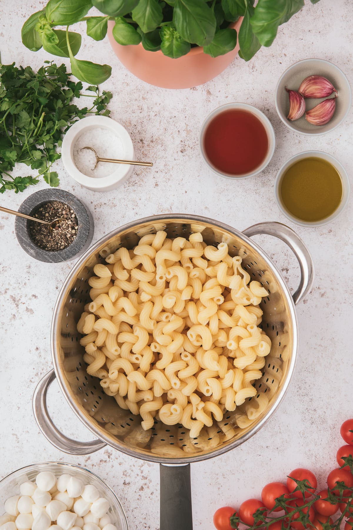 Cooled pasta for caprese pasta salad with other ingredients on the side