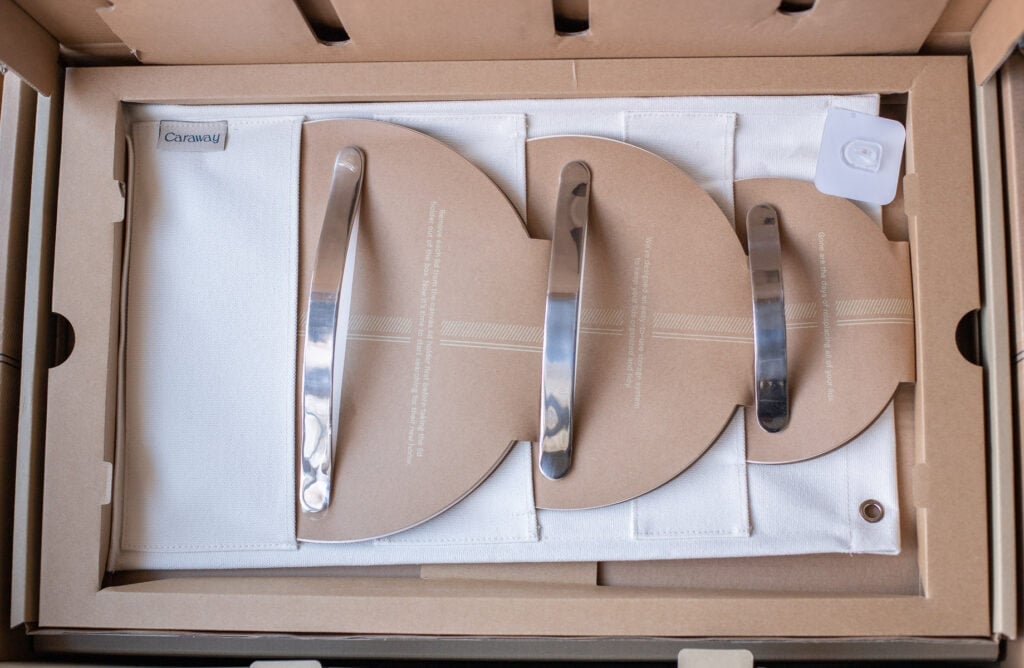 A close up of Caraway cookware in the box being unopened