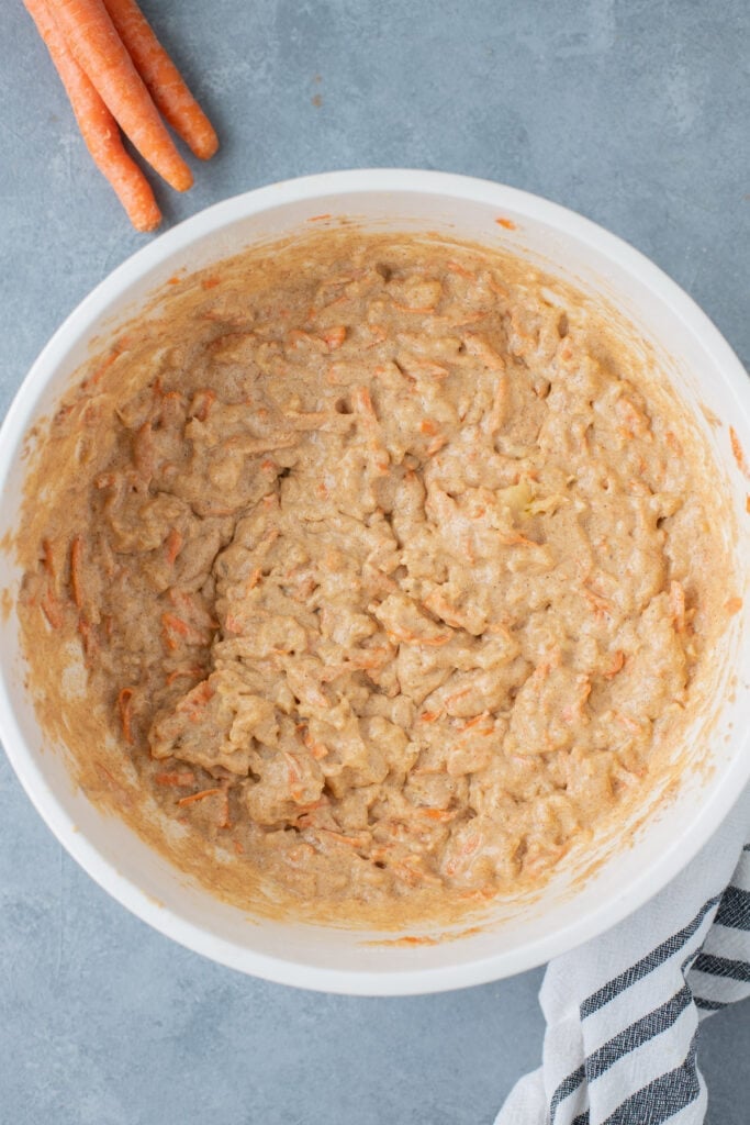 Batter for pineapple carrot muffins mixed together in a white bowl