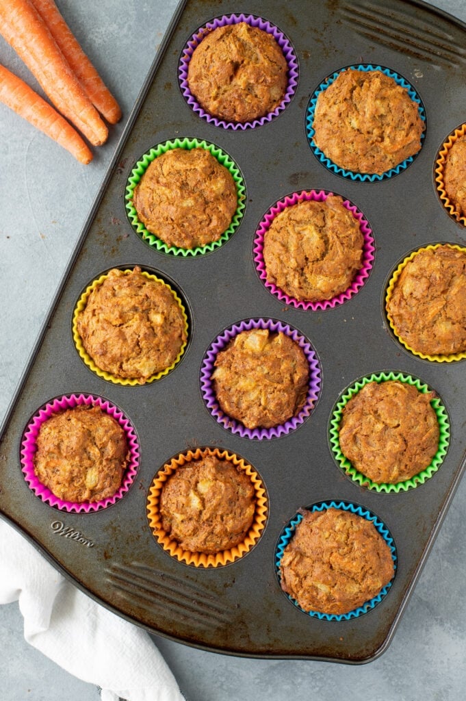Healthy Carrot Cake Muffins in a metal muffin pan fresh out of the oven