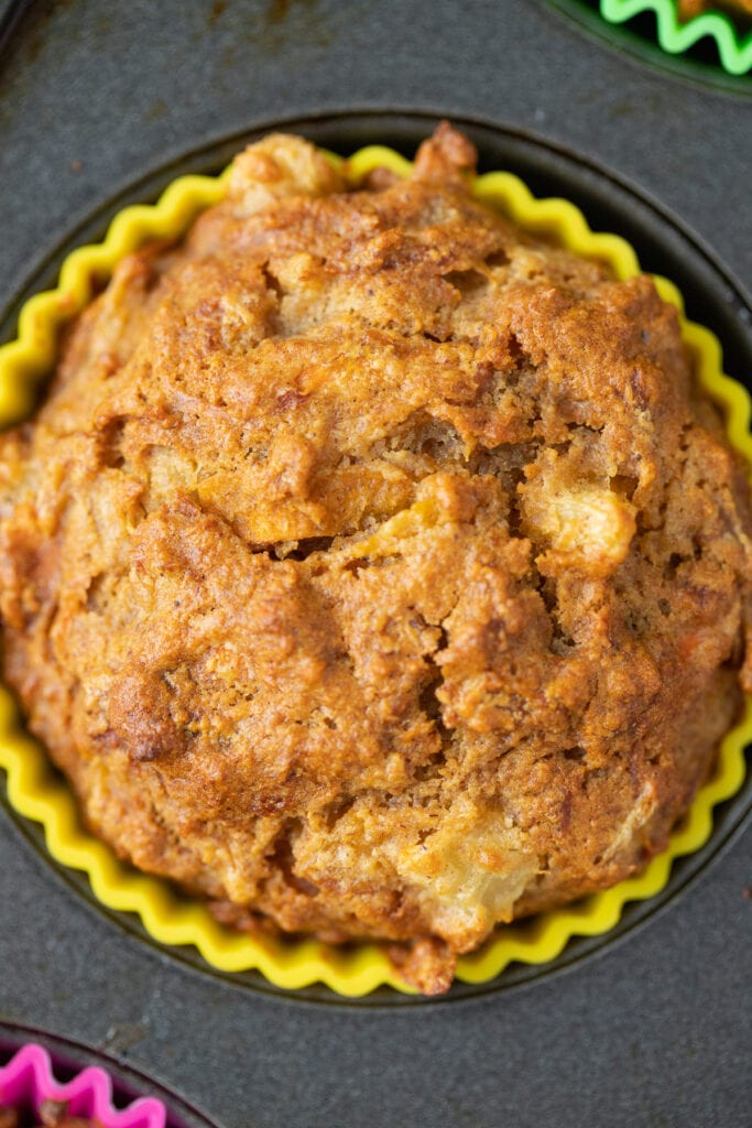 A close up of a healthy carrot muffin in a muffin tin.
