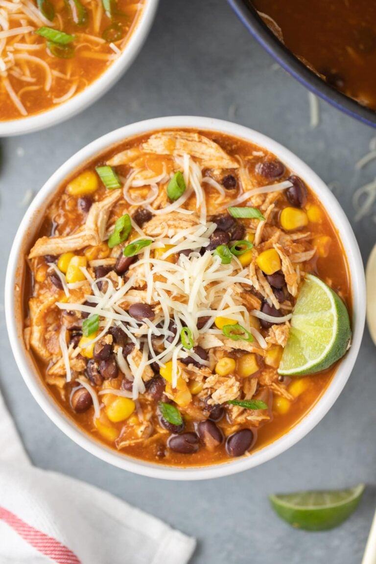 An overhead shot of chicken taco soup in a white bowl with another bowl to the side