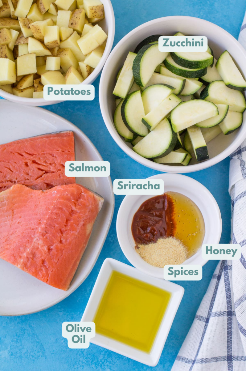Ingredients for Honey Sriracha Salmon on a blue background in small white bowls