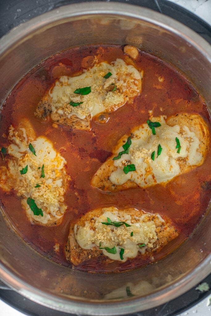 Fully cooked keto chicken parmesan with melted cheese on top in an instant pot