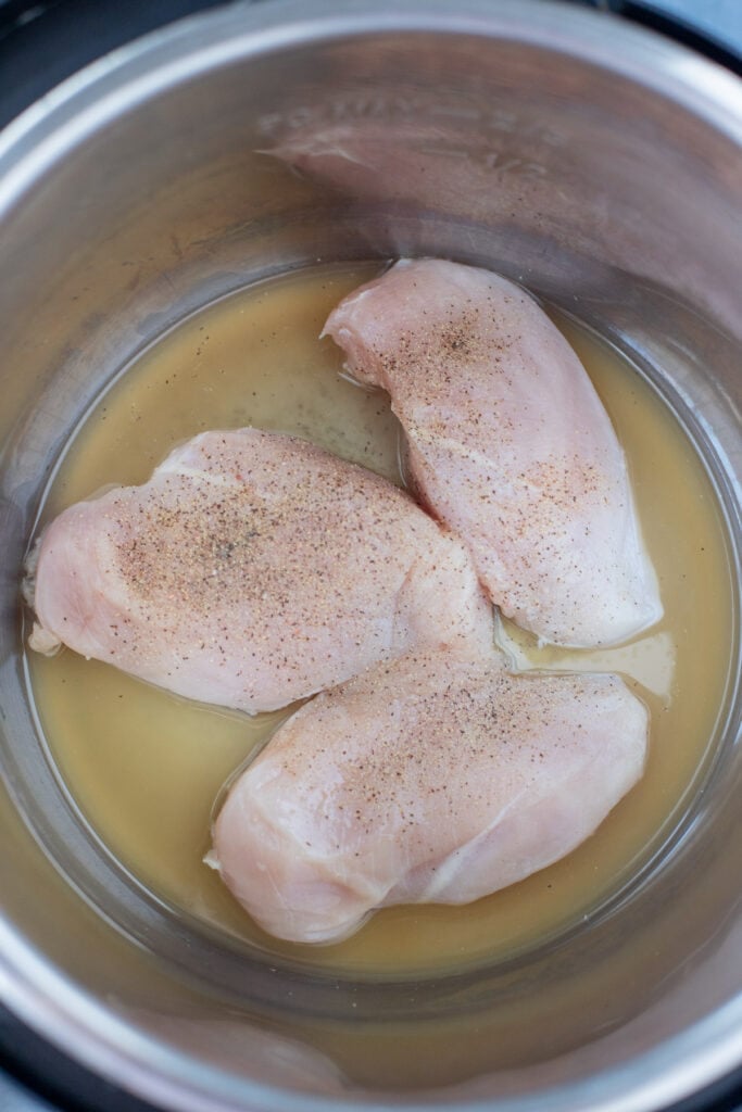 Raw Chicken breasts in an instant pot before being cooked for instant pot shredded chicken