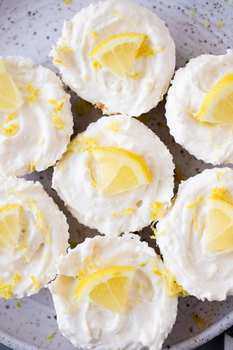 Mini lemon cheesecakes on a small white speckled plate