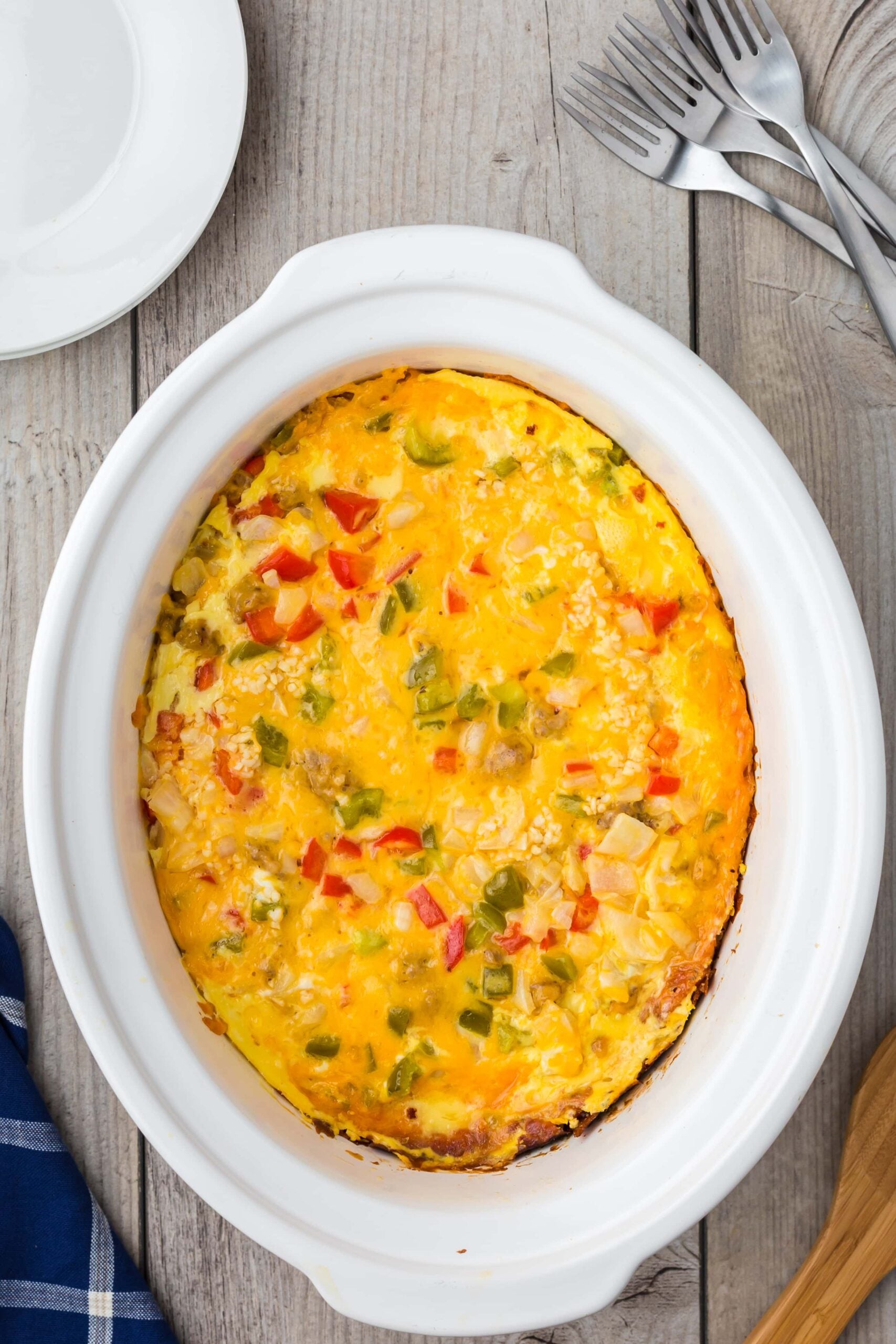 Fully cooked crock pot breakfast casserole in a white crockpot base