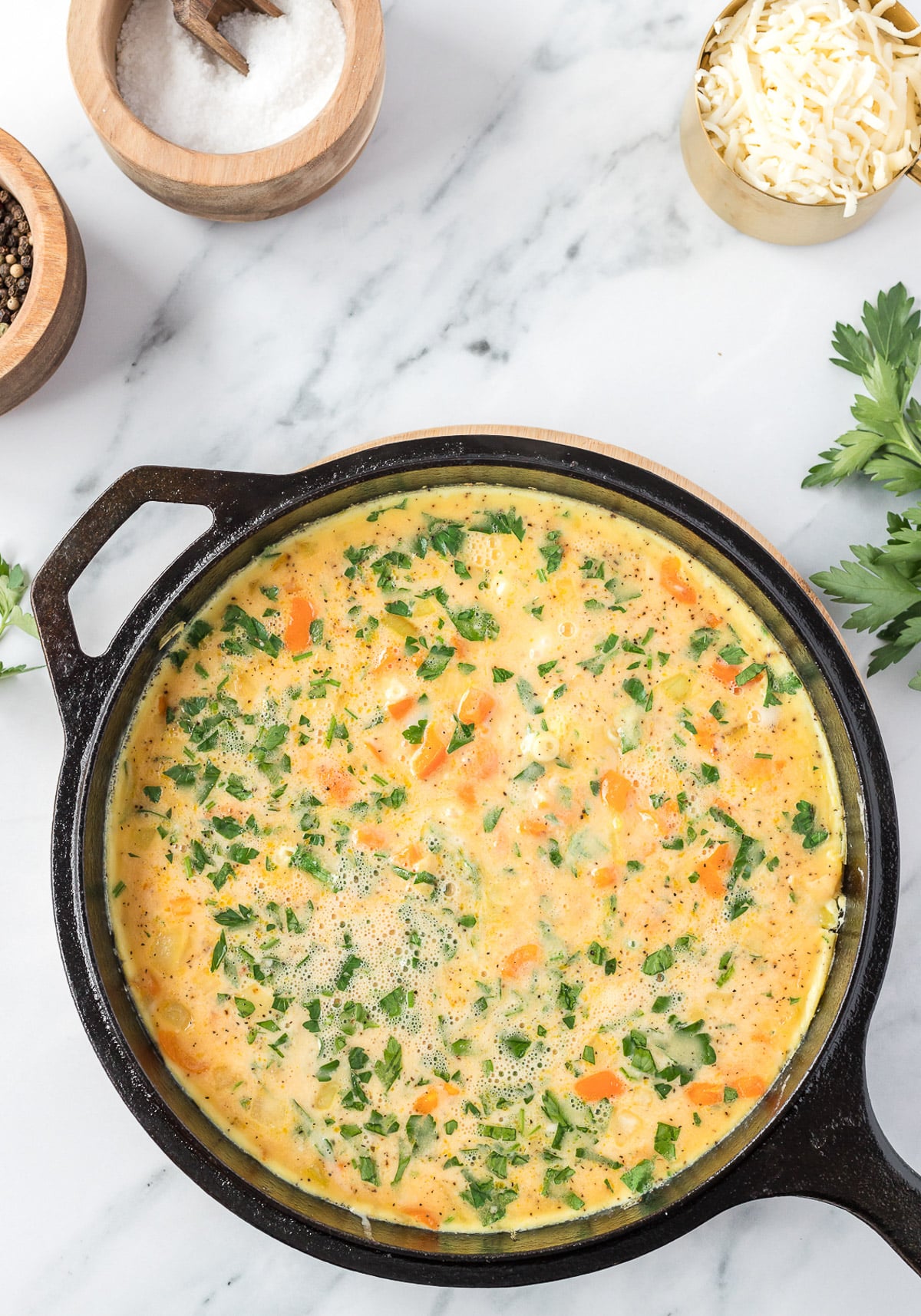 vegetable frittata in a cast iron skillet after being cooked without the toppings