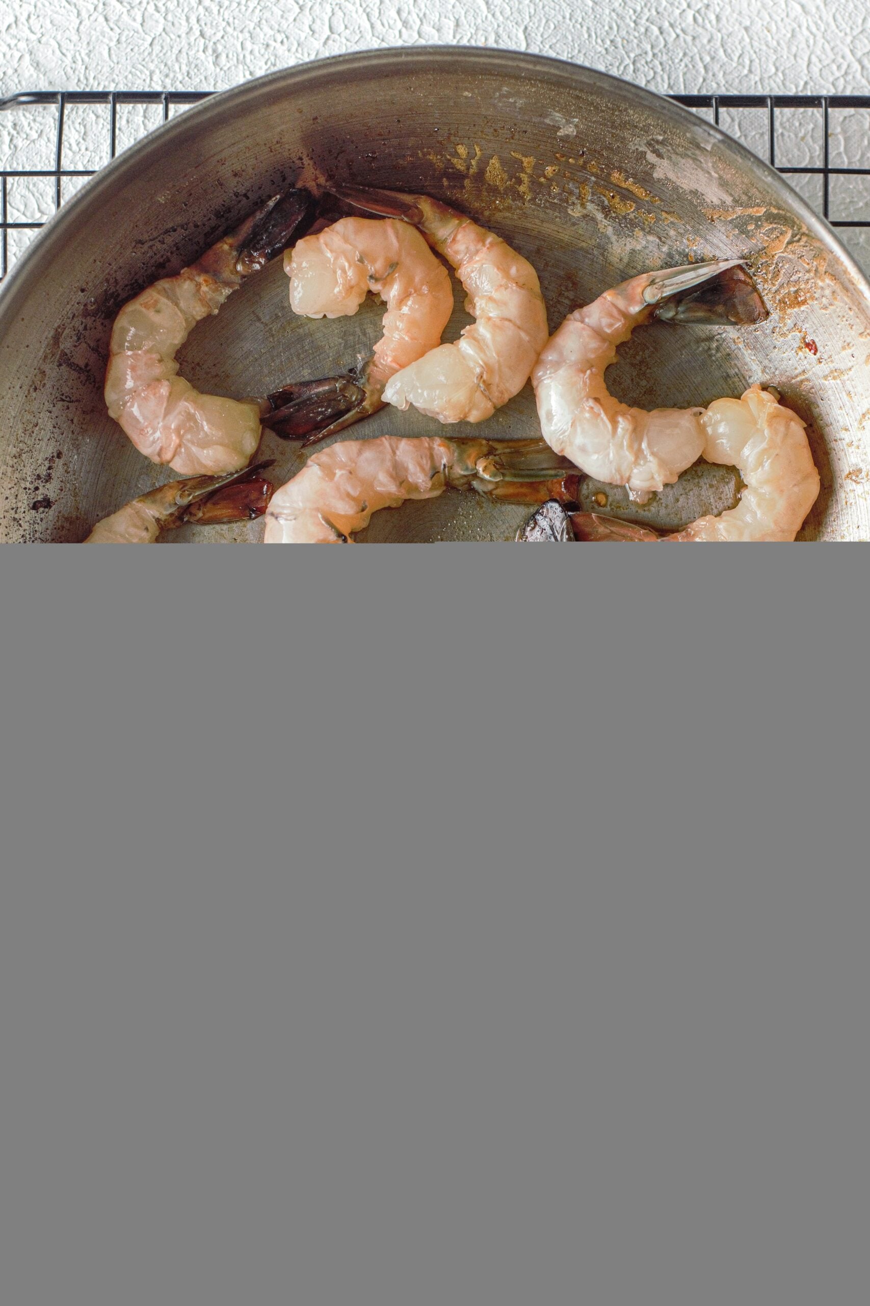 raw shrimp in a pan to be cooked for honey garlic shrimp