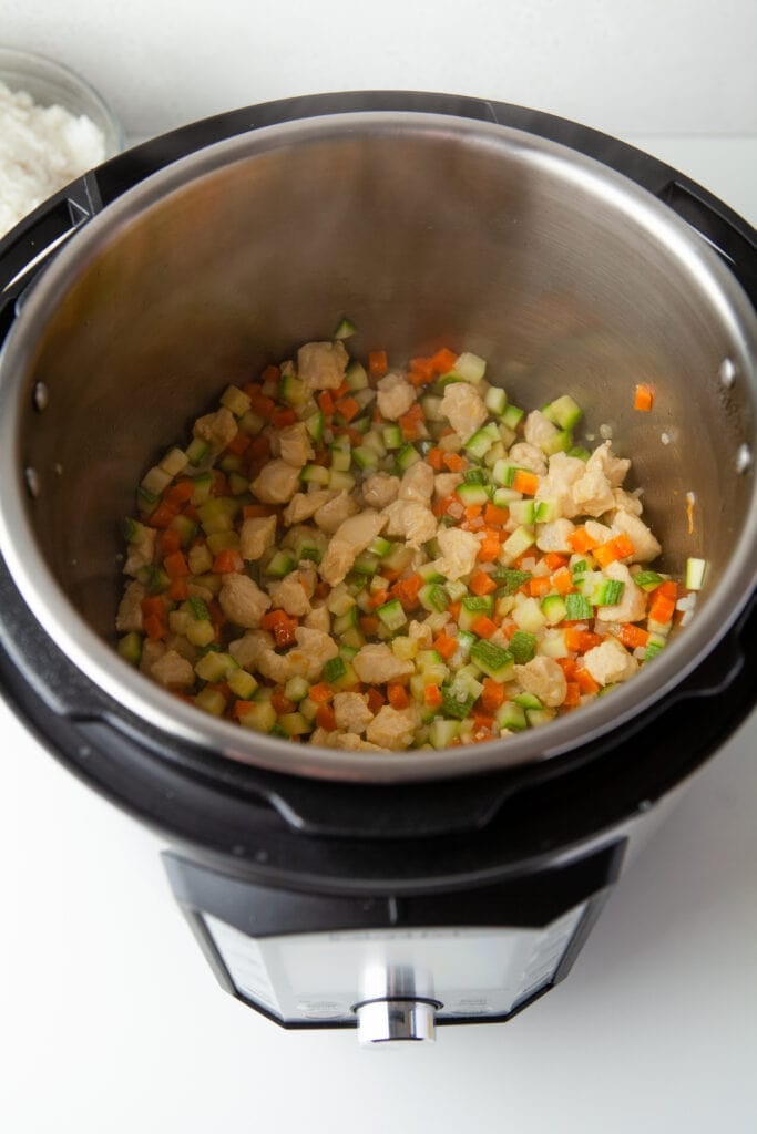 veggies and chicken sauteing in an instant pot for instant pot fried rice