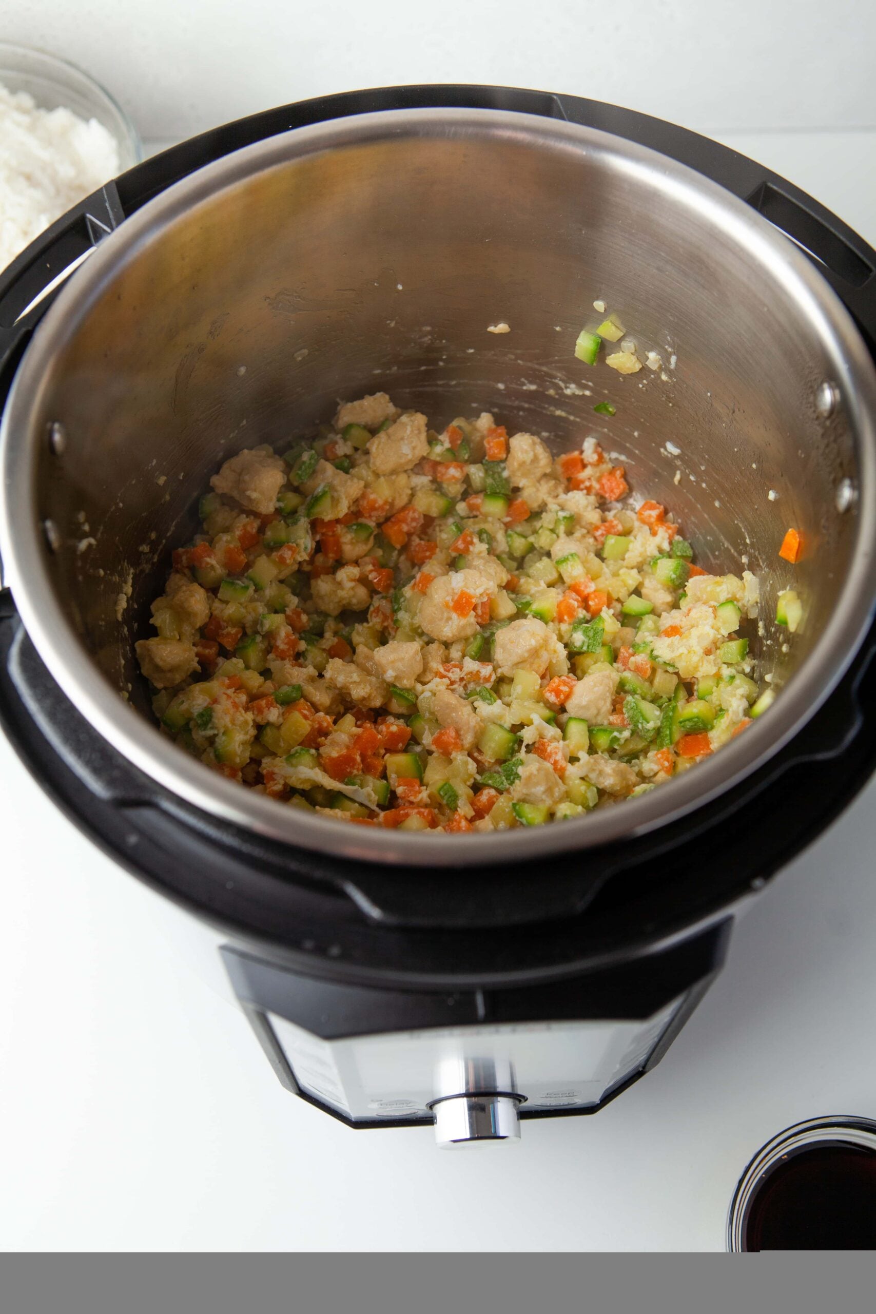 Veggies, chicken and eggs sauteing in an instant pot for instant pot fried rice