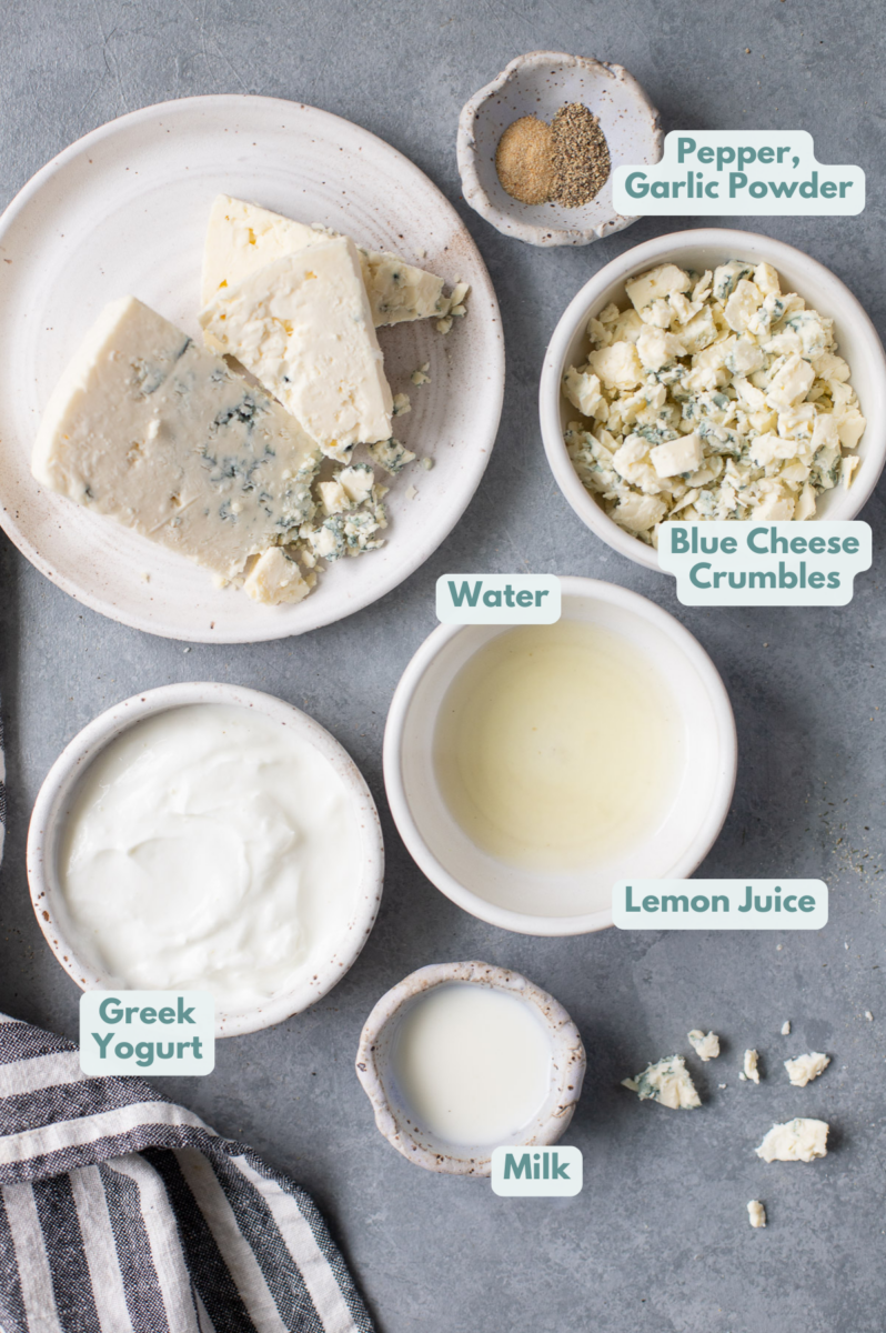 Ingredients for Greek Yogurt Blue Cheese Dressing in small white bowls