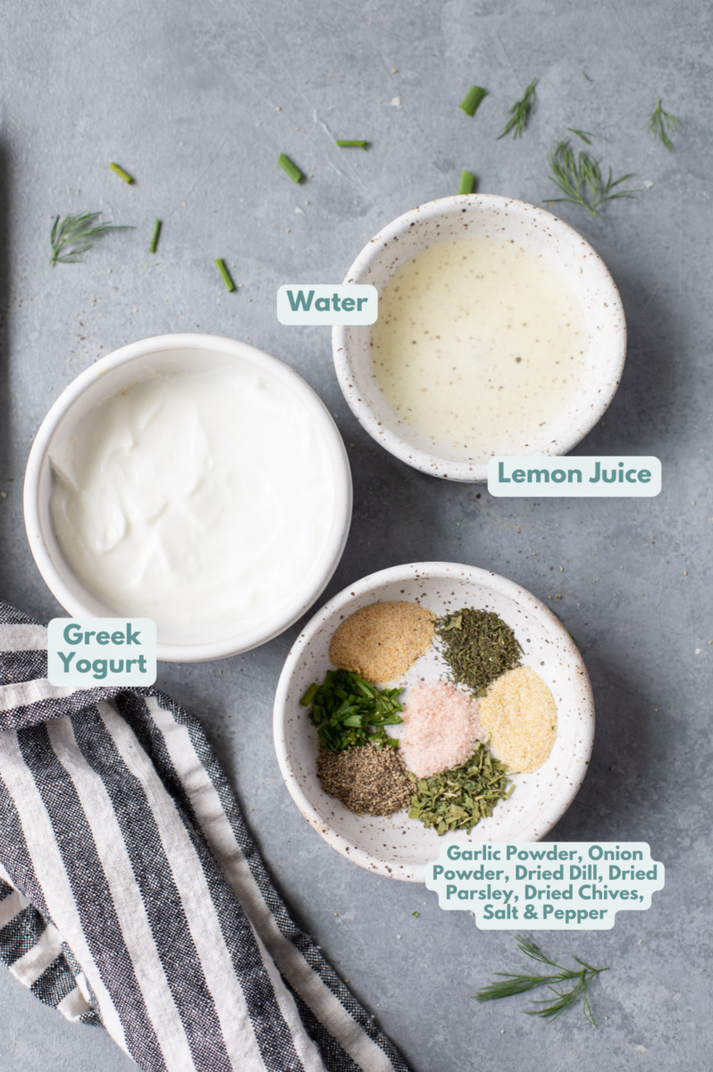 Ingredients for Healthy Ranch Dressing in small white bowls on a grey background