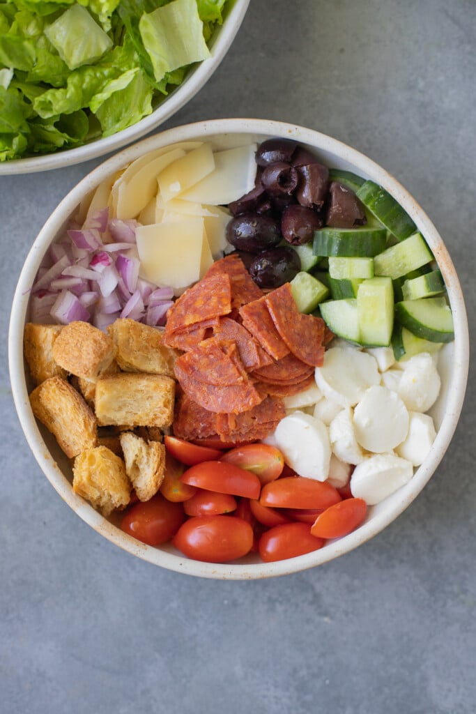 An overhead shot of topping for a chopped italian salad