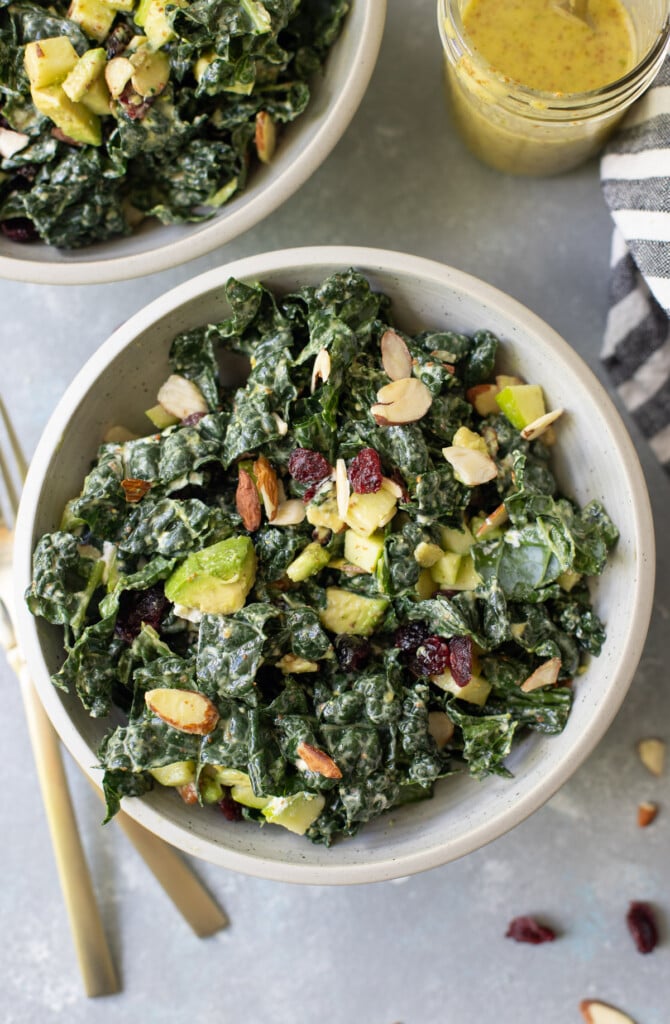 A close up of simple kale salad in a grey bowl