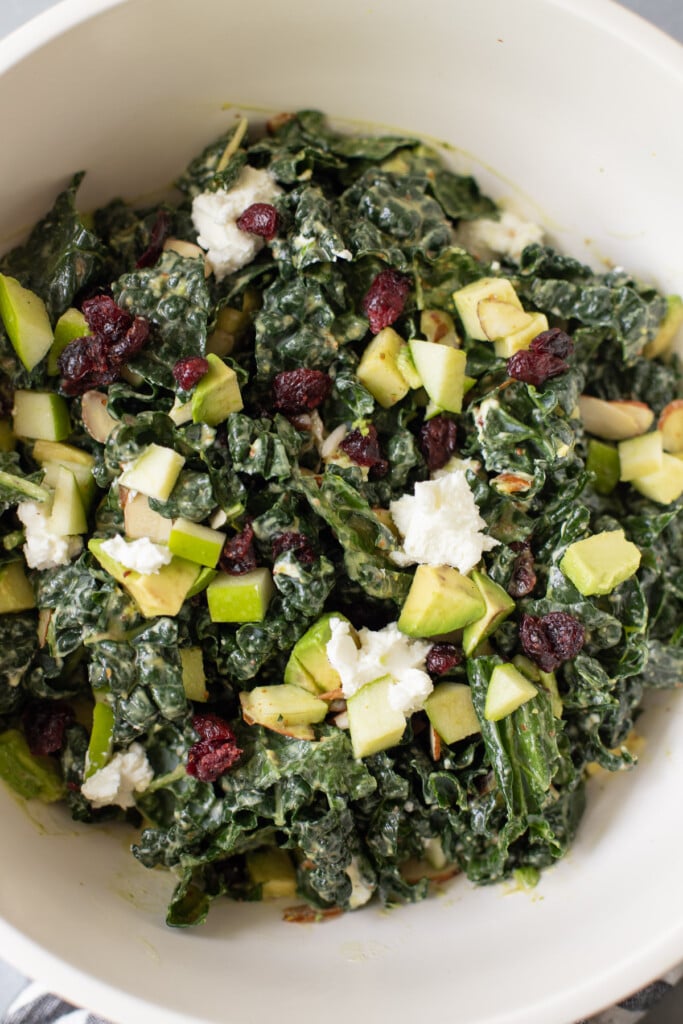 A close up of a bowl of summer kale salad in a big white bowl