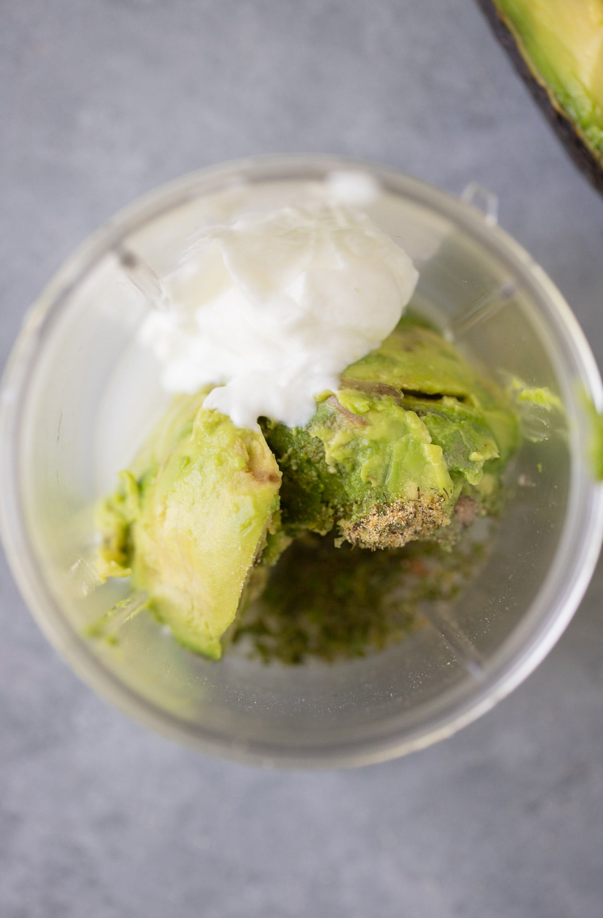 creamy avocado dressing ingredients in a blender before being blended up